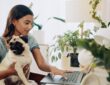 Dog, research and laptop with woman in home office for social media, communication and pet adoption