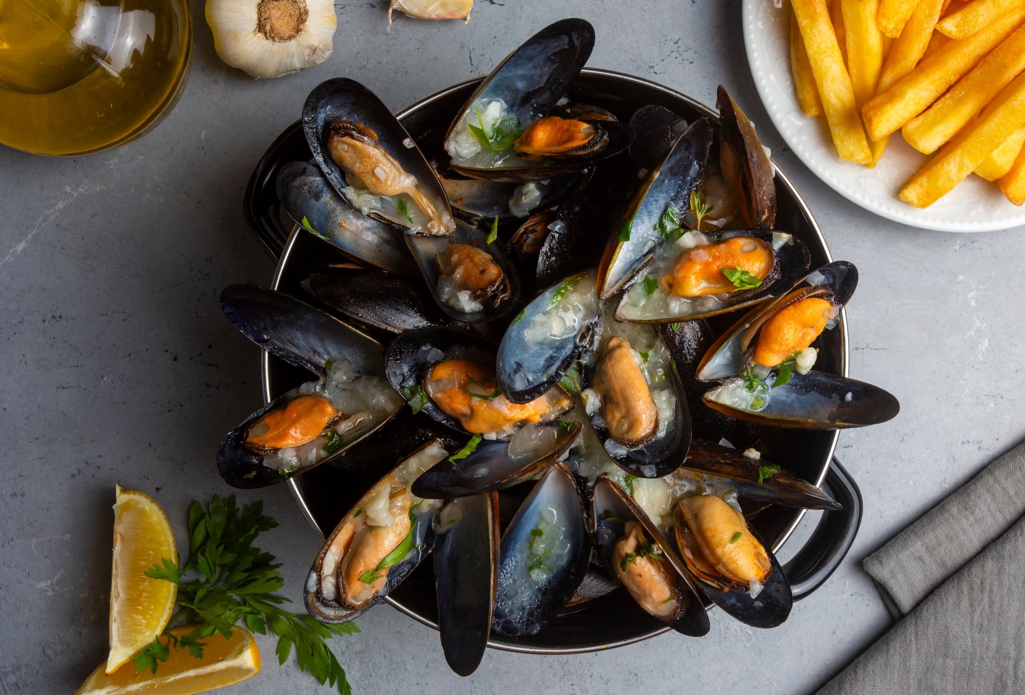 Delicious seafood mussels with parsley sauce and lemon. Delicious steamed mussels.