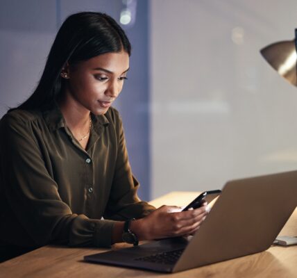 Laptop, phone and business woman on coding, software development and programming script for cyberse
